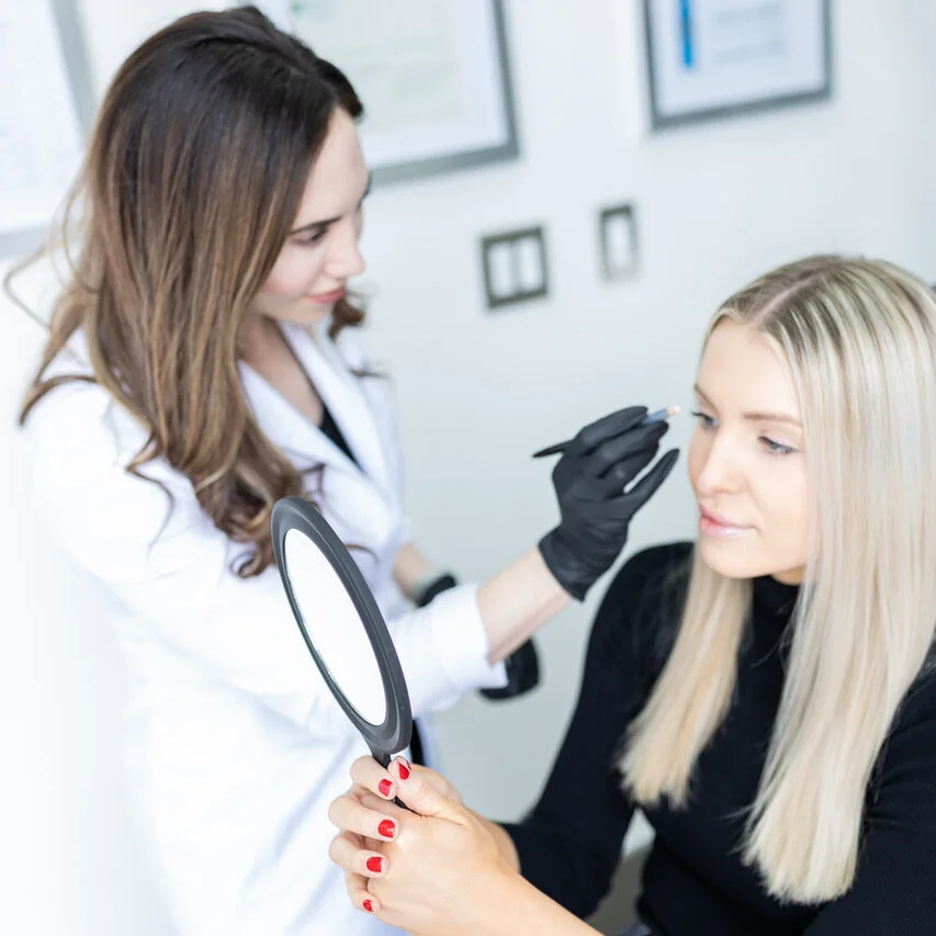 Nurse Jacklyn reviewing a treatment plan for non-surgical eyelift