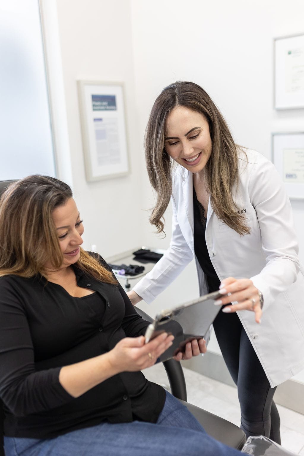 Nurse Jacklyn reviewing a cosmetic injectable treatment plan with a patient in Oakville.