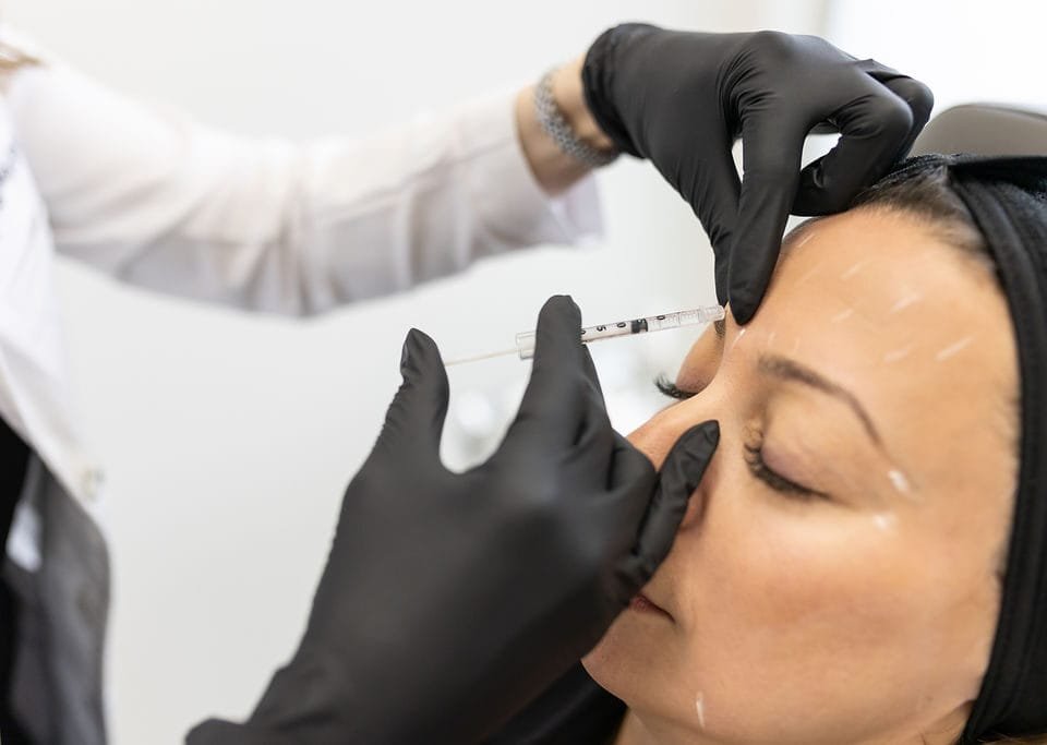Close-up of a cosmetic neuromodulator injection being performed during a Botox appointment.
