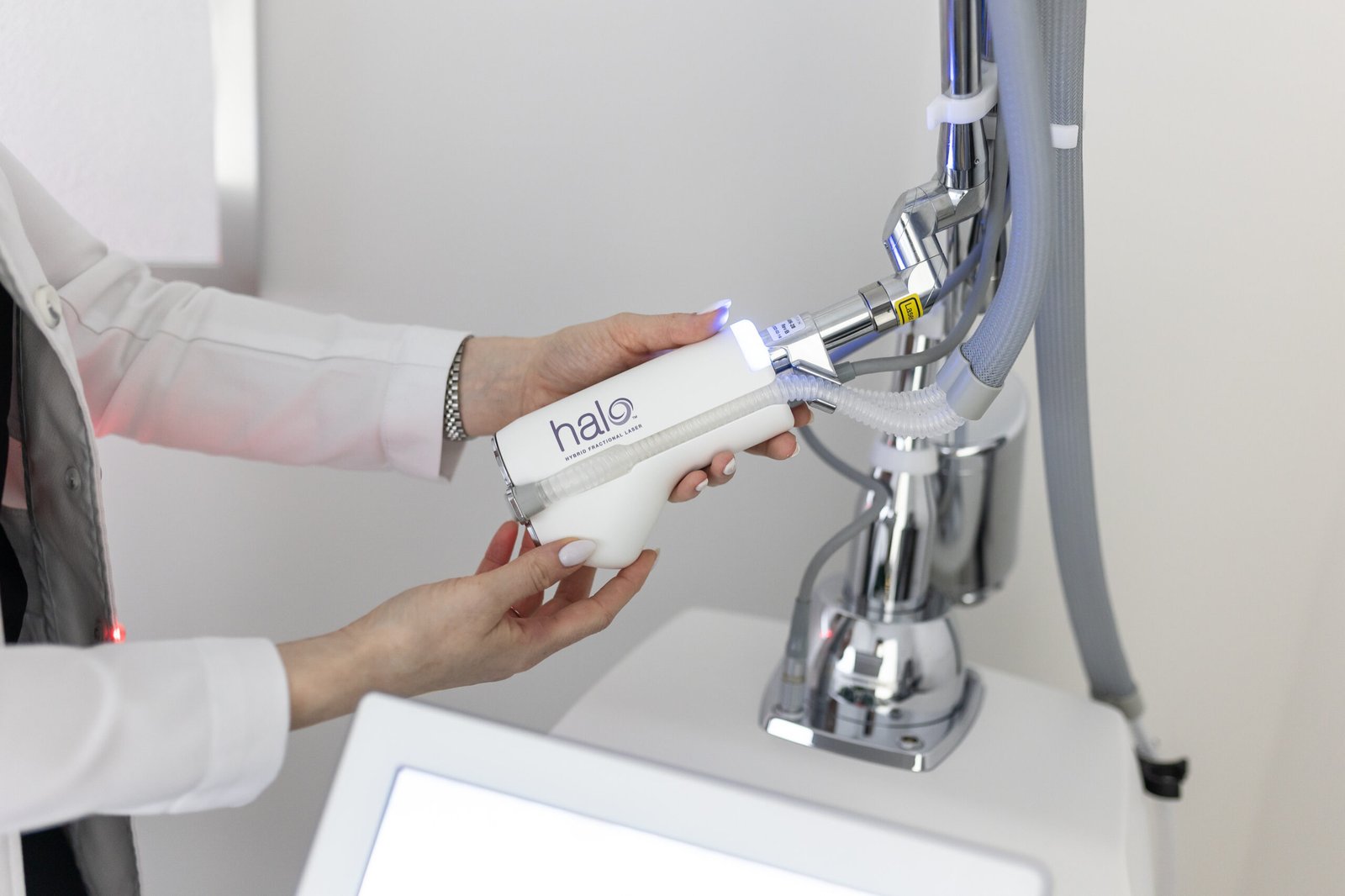 Practitioner holding the HALO hybrid fractional laser handpiece